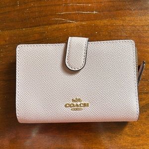 Light pink Coach wallet.